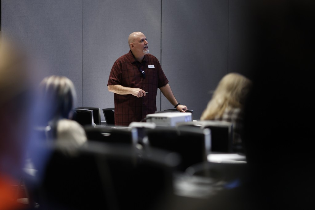 A shot of me presenting at the session below.